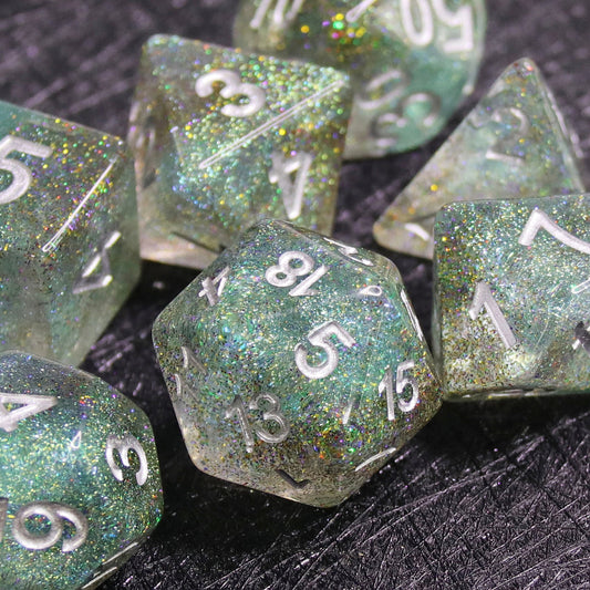 Set of green glittery polyhedral dice on a dark surface