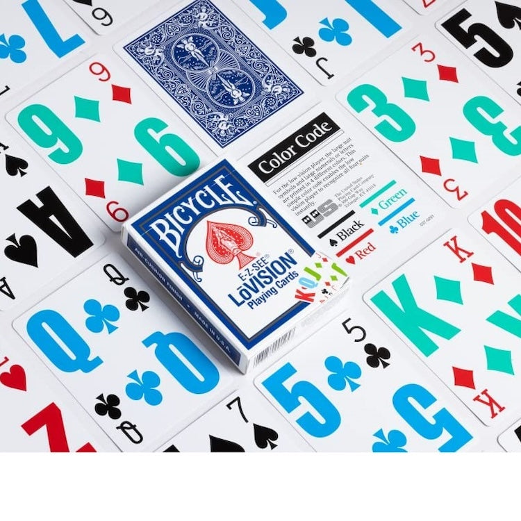 Bicycle Lovision playing cards with a blue and red spade deck box, surrounded by scattered playing cards showing different suit colors on a white background.