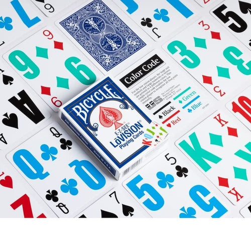 Bicycle Lovision playing cards with a blue and red spade deck box, surrounded by scattered playing cards showing different suit colors on a white background.