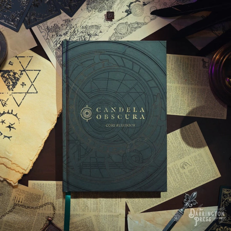 The image shows the Candela Obscura Core Rulebook, a tabletop role-playing game. The book's cover is adorned with intricate, dark green illustrations and text, set against a backdrop of old papers and esoteric imagery including a telescope, human skulls, and geometric shapes.