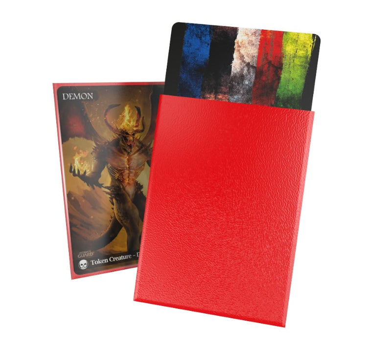 A red Matte Cortex sleeve by Ultimate Guard displayed alongside a trading card game card, showcasing the sleeve's transparency and fit.